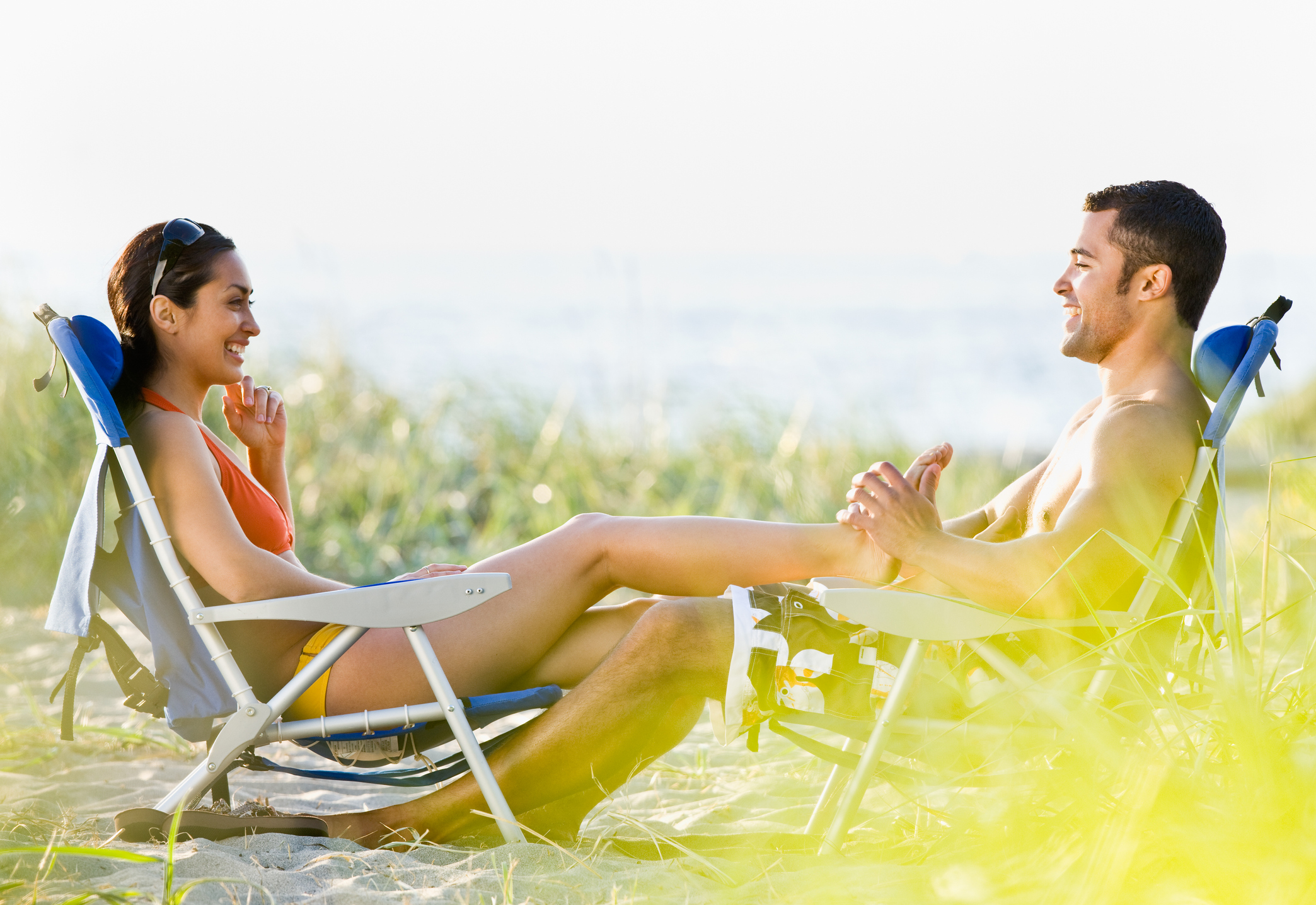 Boyfriend Giving Girlfriend Foot Massage at Beach