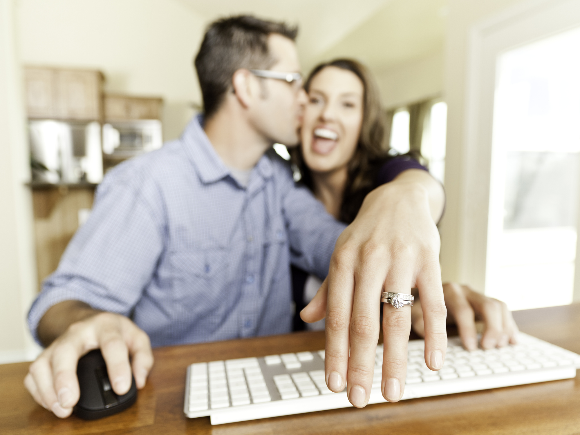 Engaged Young Couple Using Webcam (Video Chat)