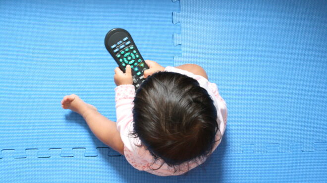 baby girl in front of tv