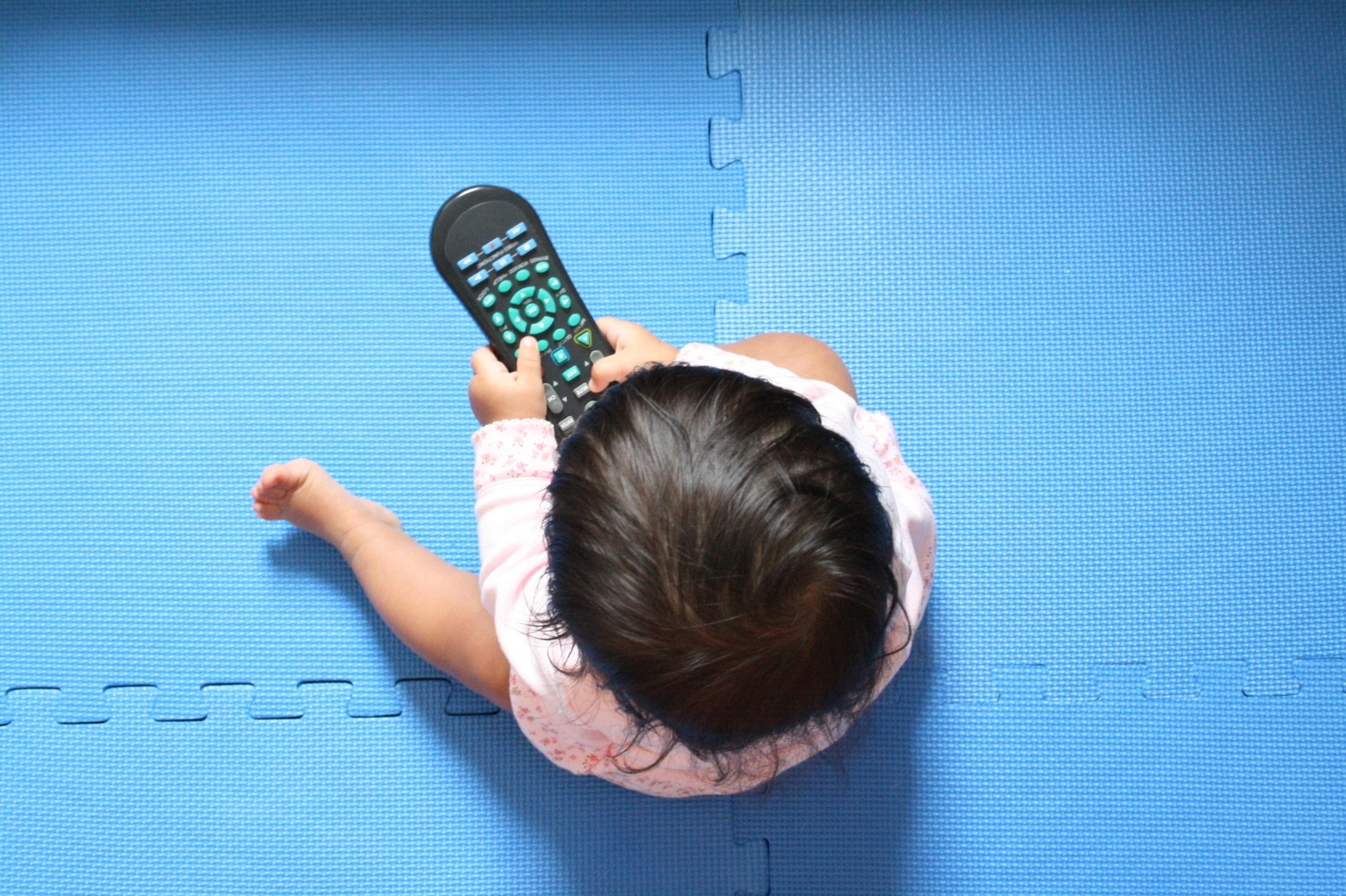 baby girl in front of tv