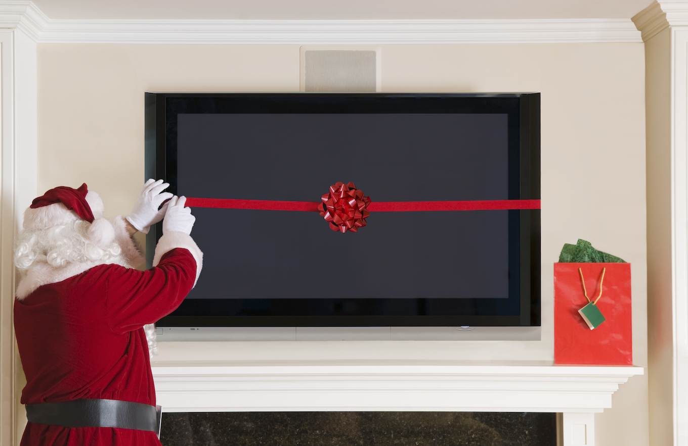 Santa Clause Wrapping a Big Screen TV