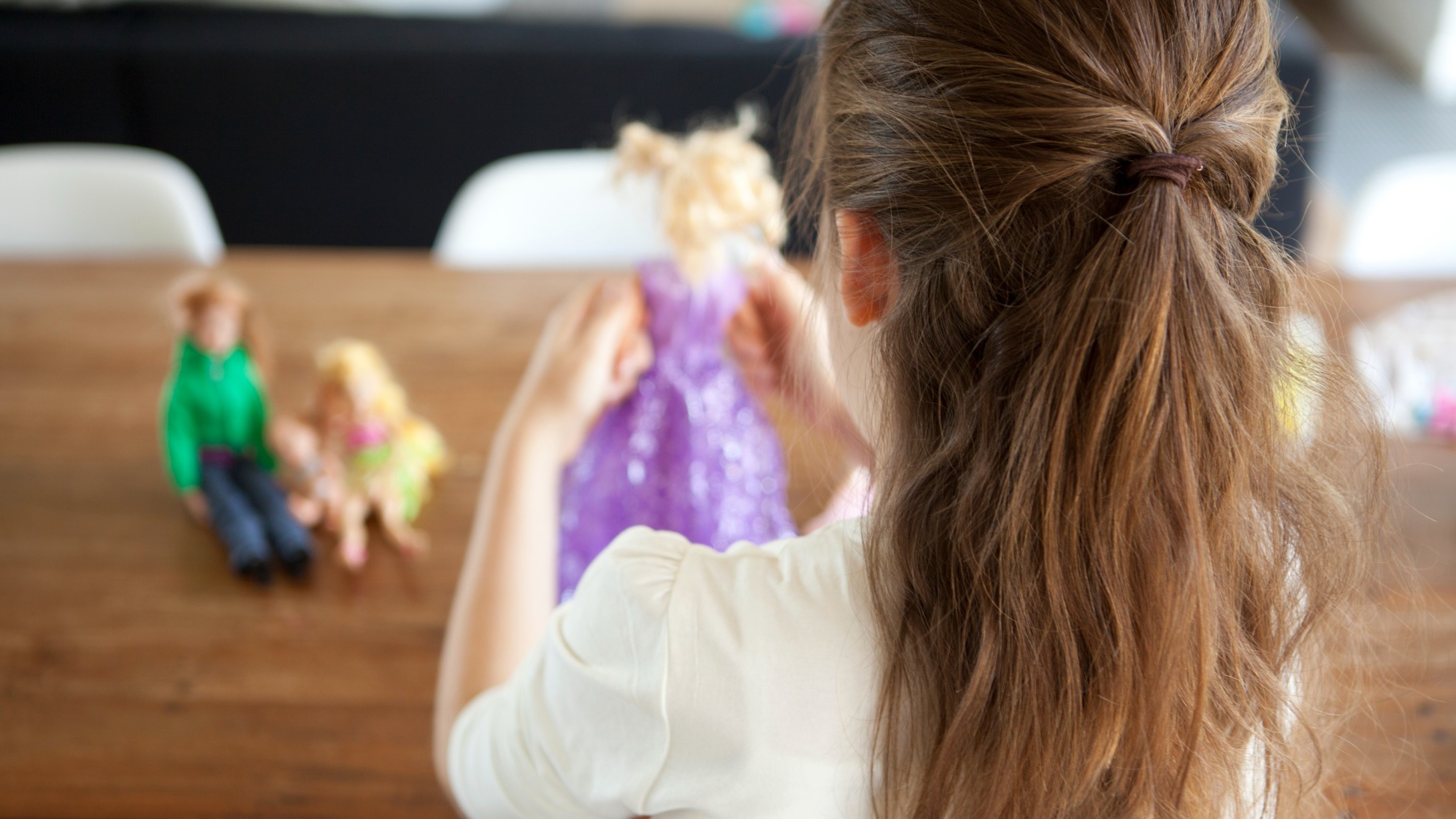 Girl playing with dolls