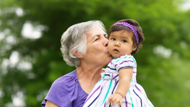 grandmother kissing granddaughter