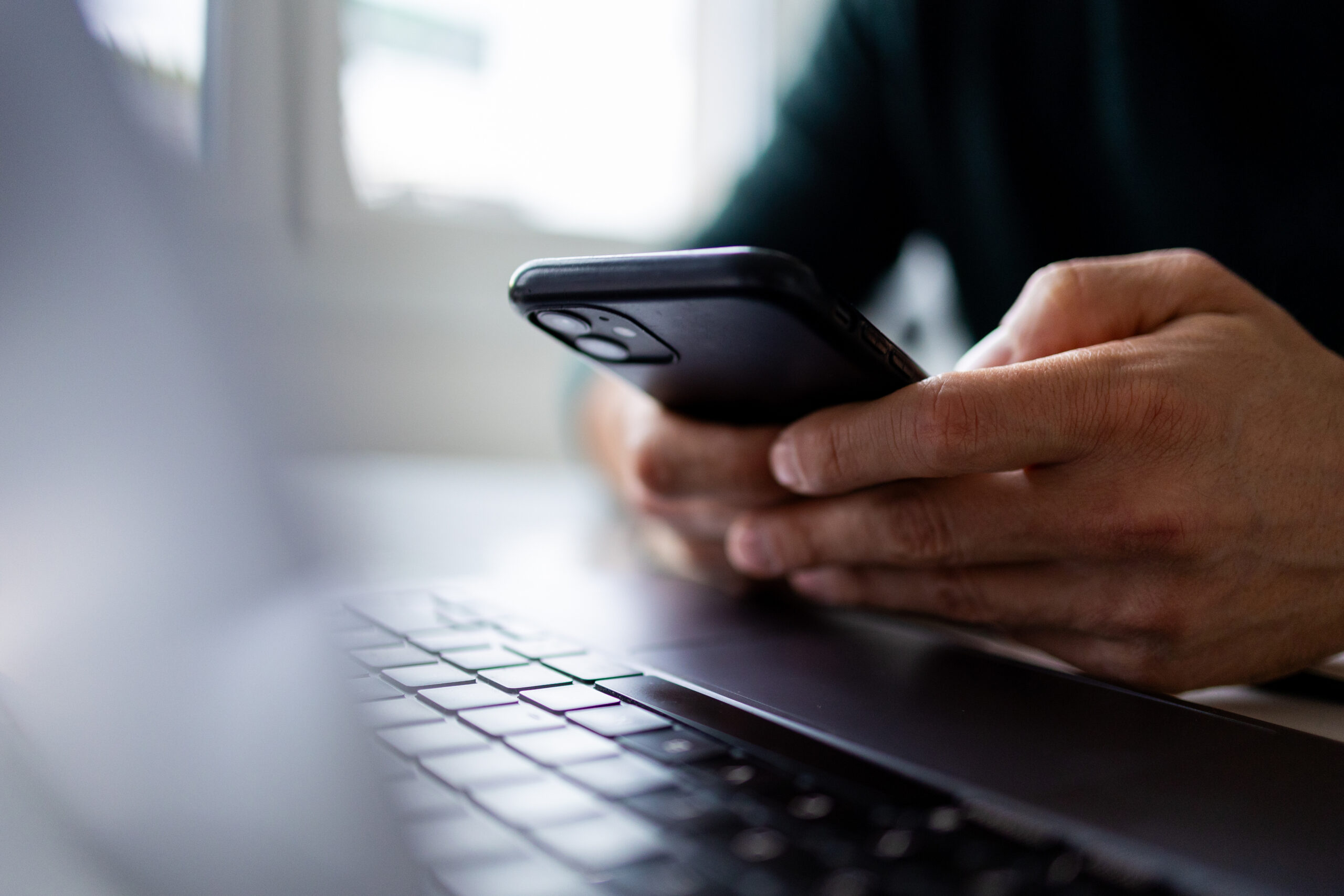 Close up on man hand using mobile phone