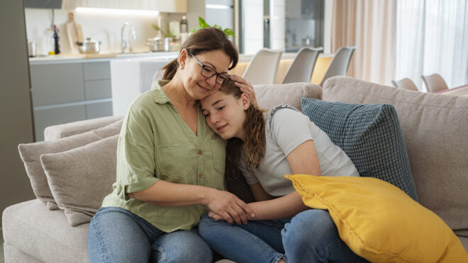 Mom hugging teenage daughter