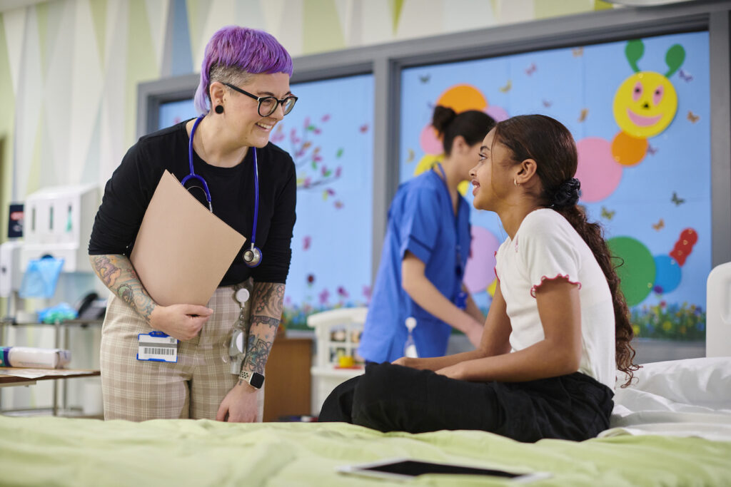little girl with paediatric doctor on hospital ward