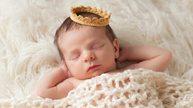 baby sleeping in a crown