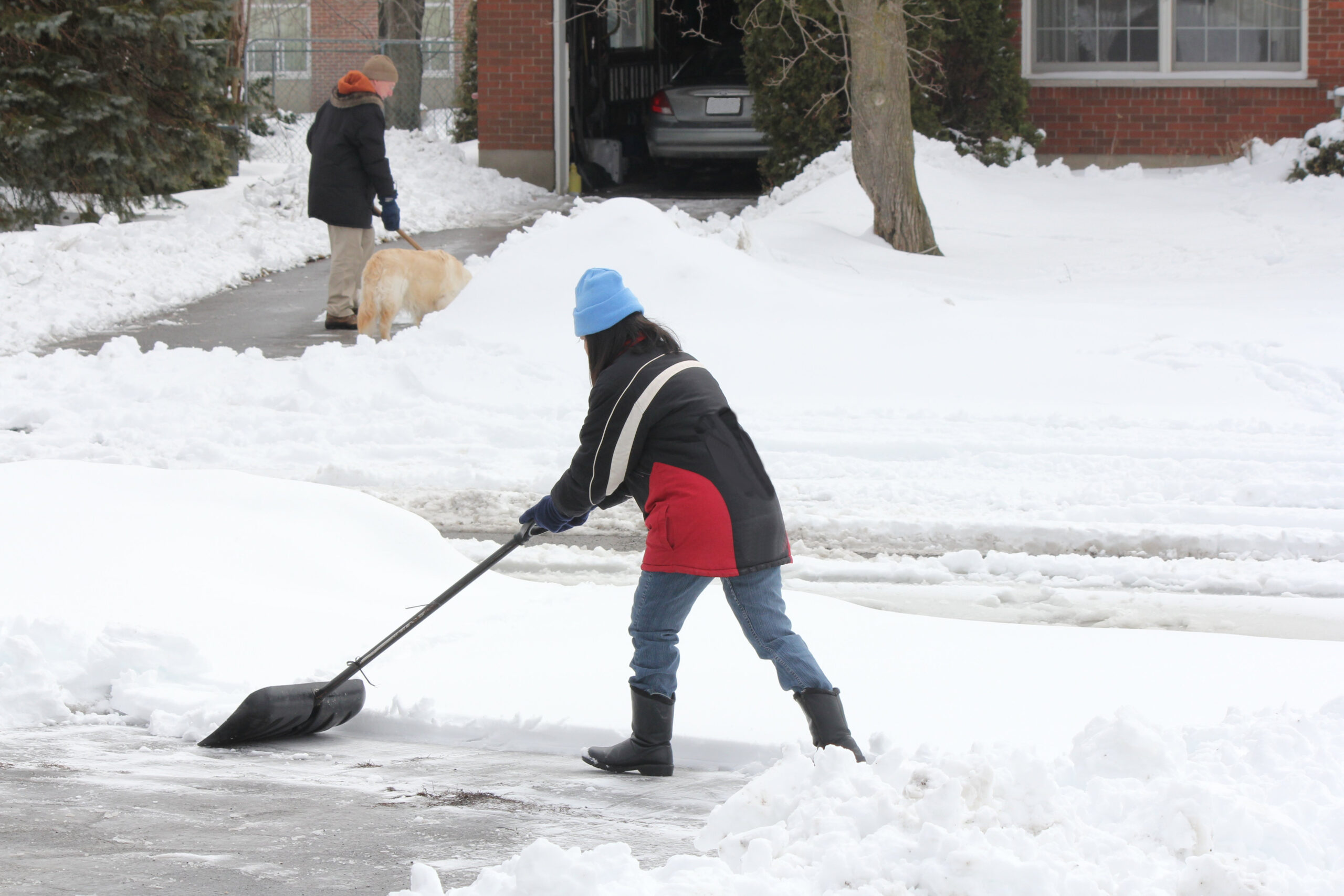 Lady & Neighbour Shoveling Snow