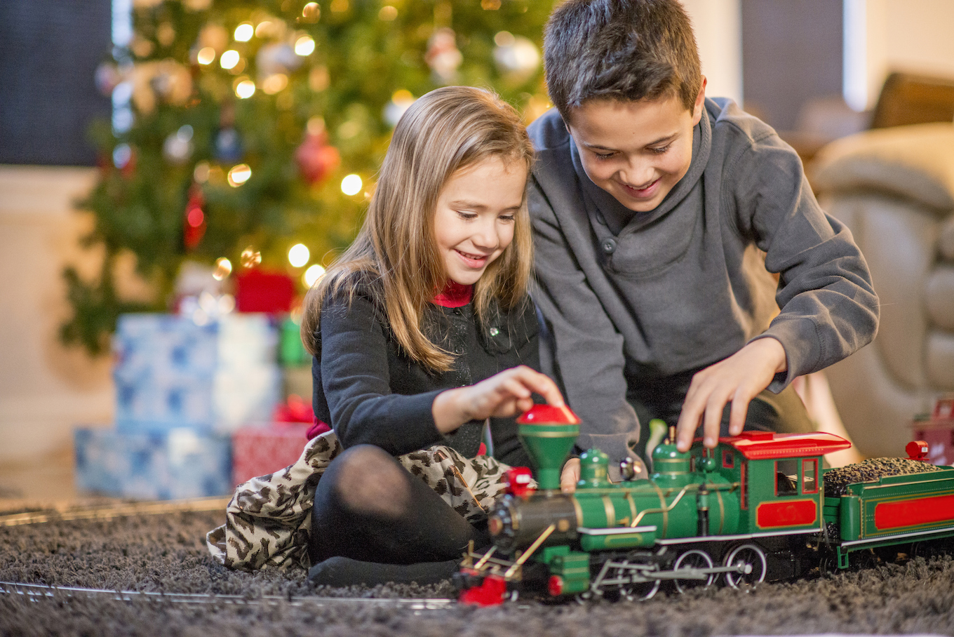 Kids playing with a Christmas train set