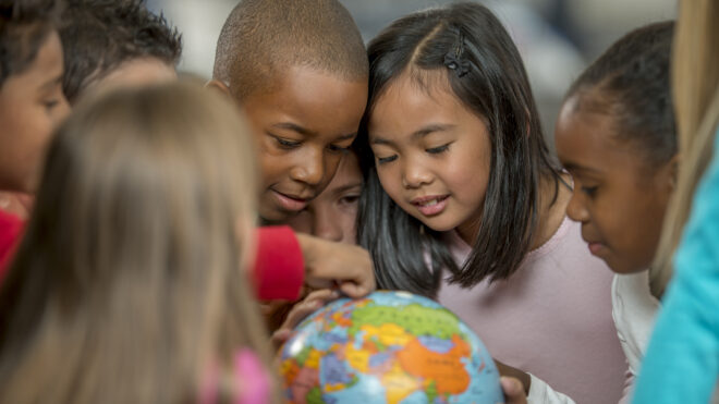 kids looking at globe