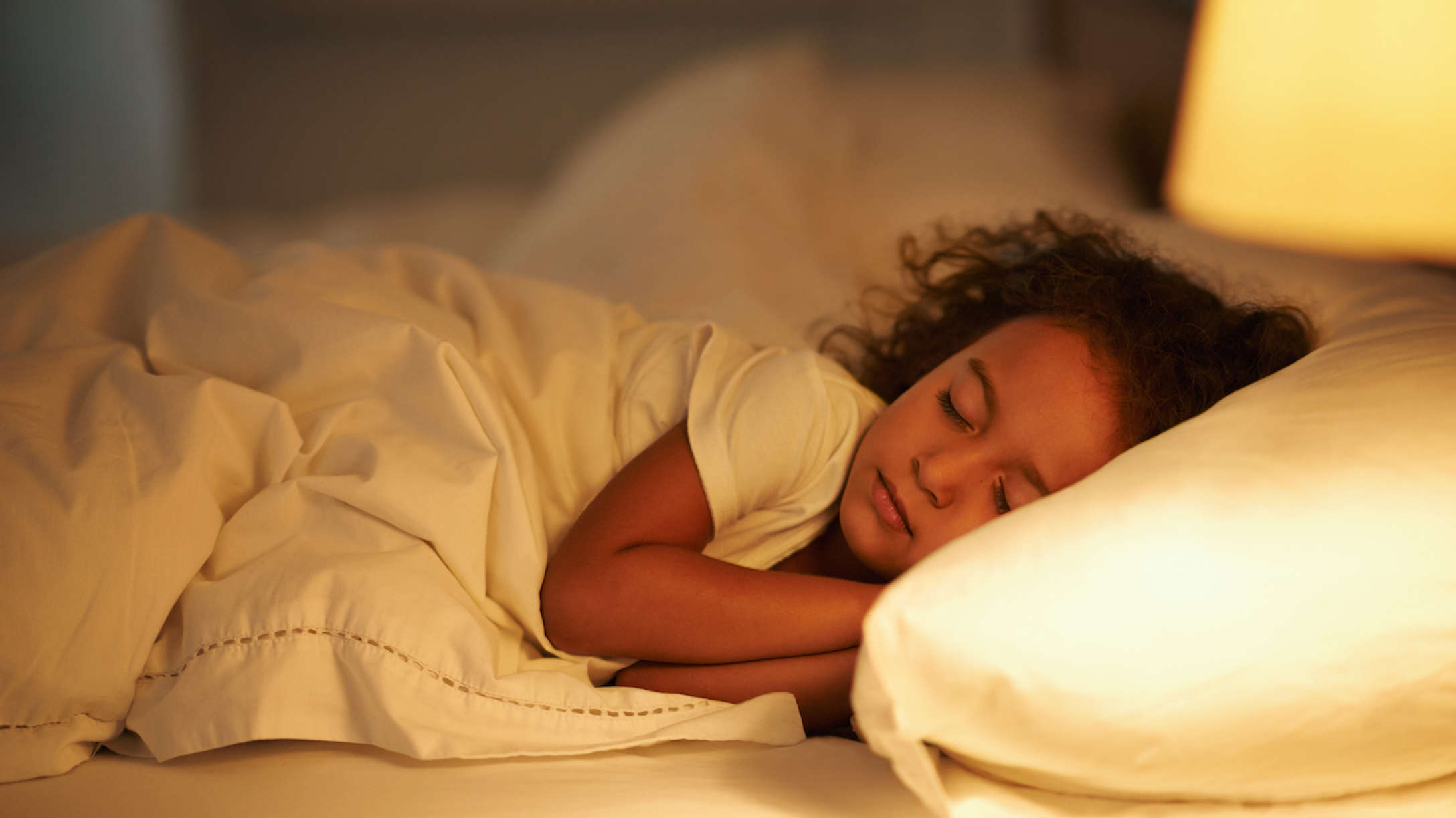 Little girl sleeping in bed