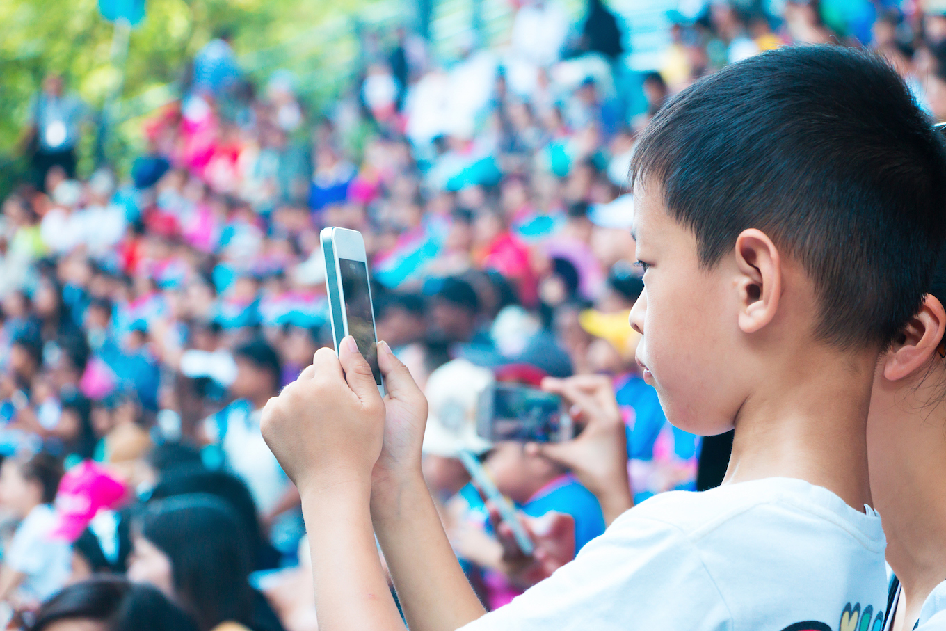 kid use smart phone to take photo in the show