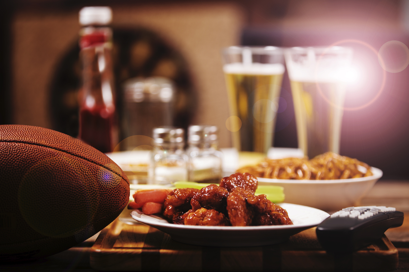 Watching television. Sports bar or local pub. Football, food, beer.