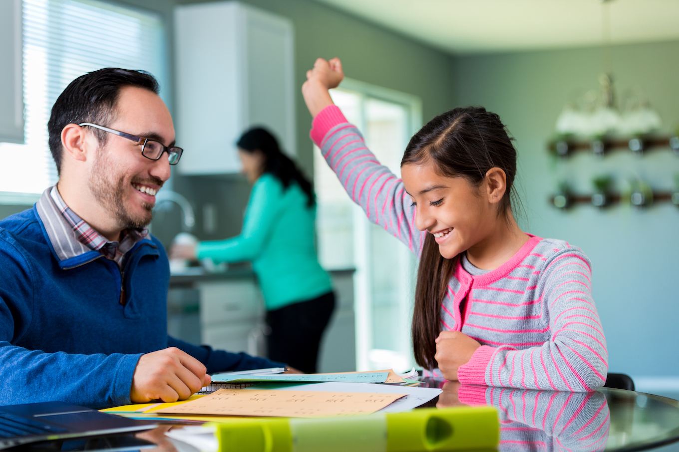 Excited pre-teen girl celebrates after finishing project