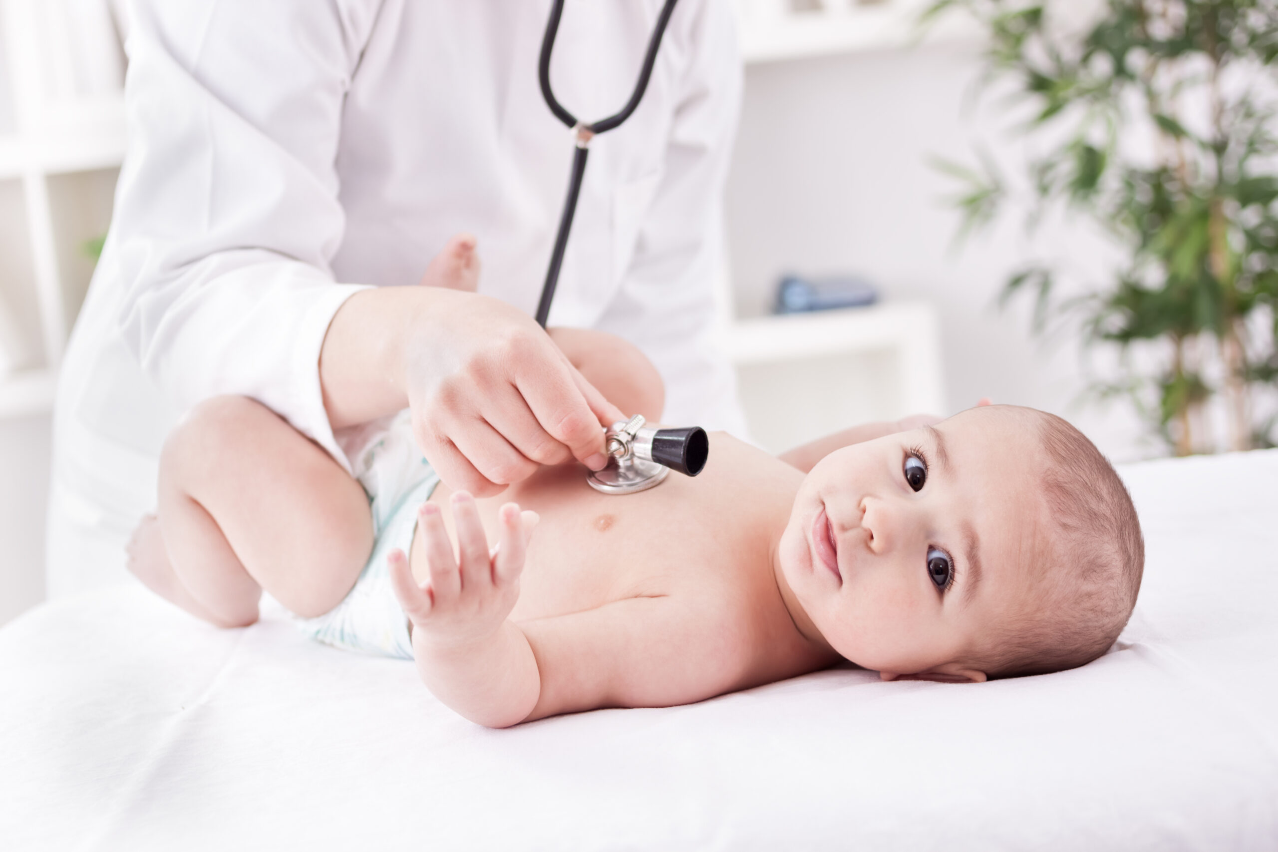 Female doctor listens to the heart with stethoscope