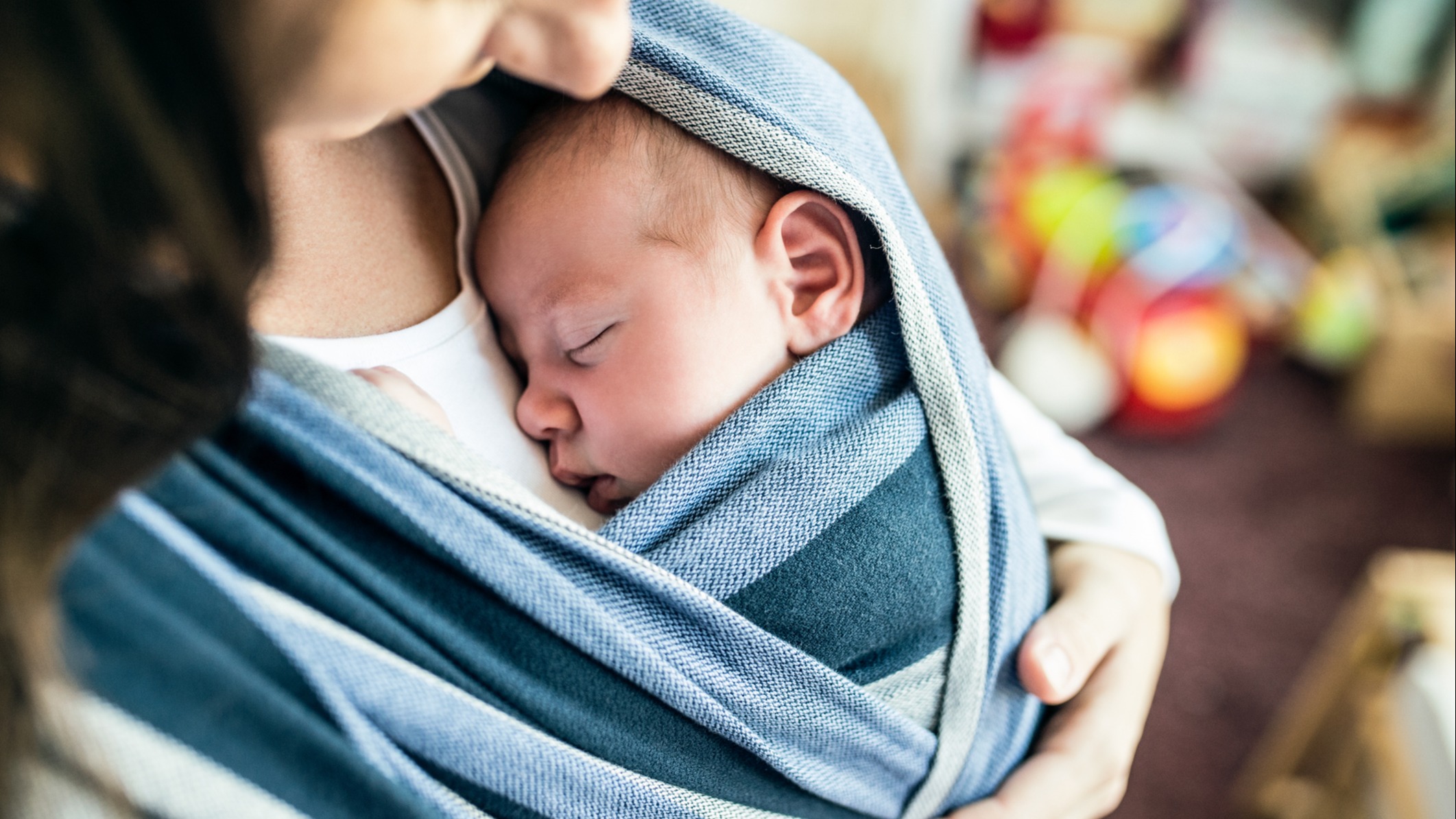 mom wearing newborn