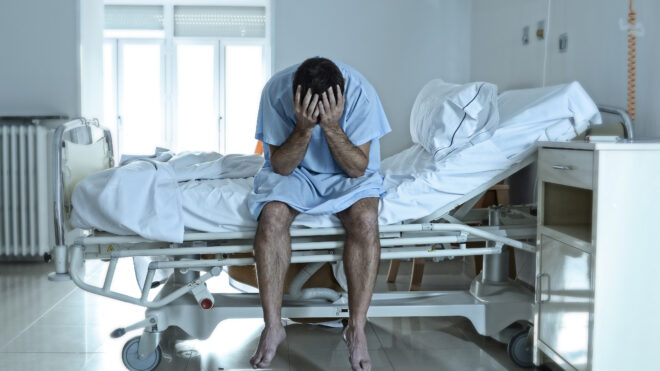 man in hospital bed