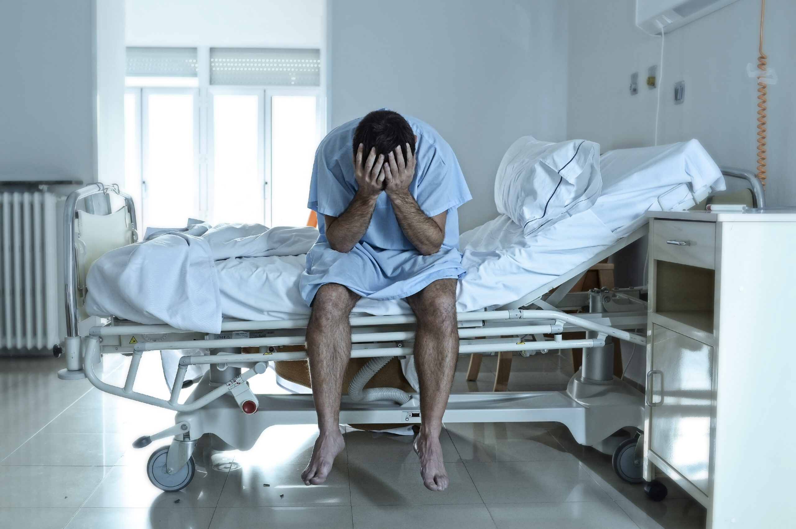 man in hospital bed