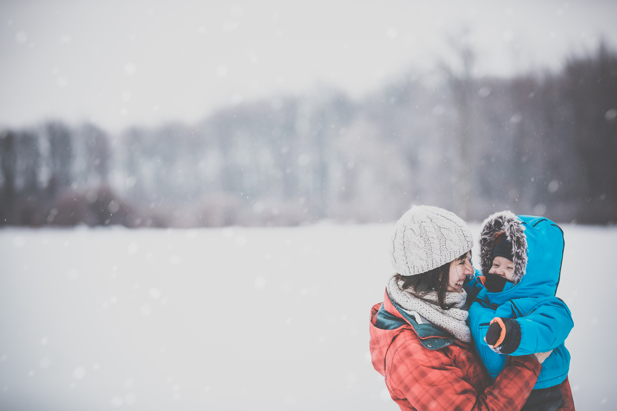 Mother and Son in Winter Forest Snowstorm