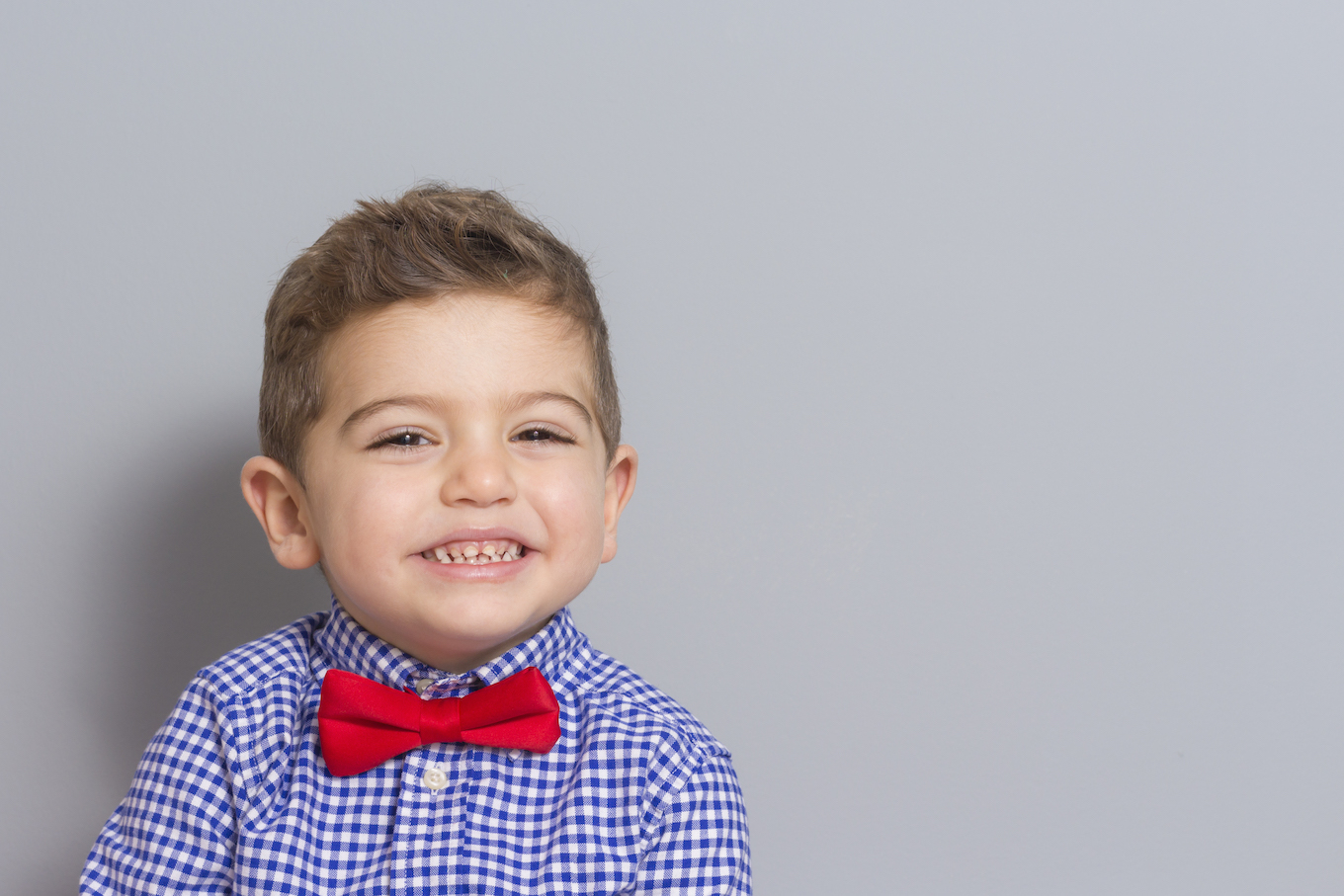 Young Boy Wearing Bow Tie Smiling