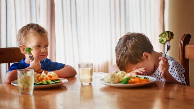 boys at dinner table not eating