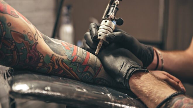 woman getting tattooed