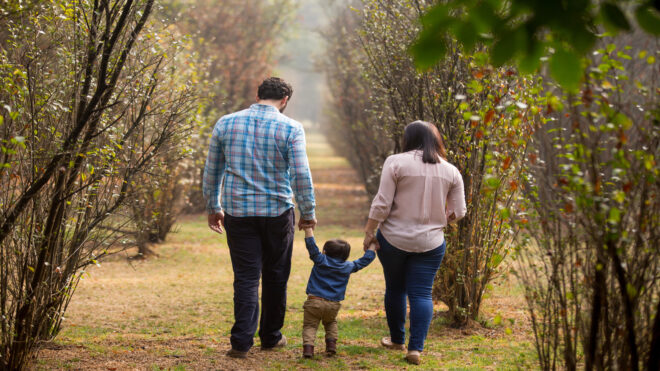 boy walking with his parents