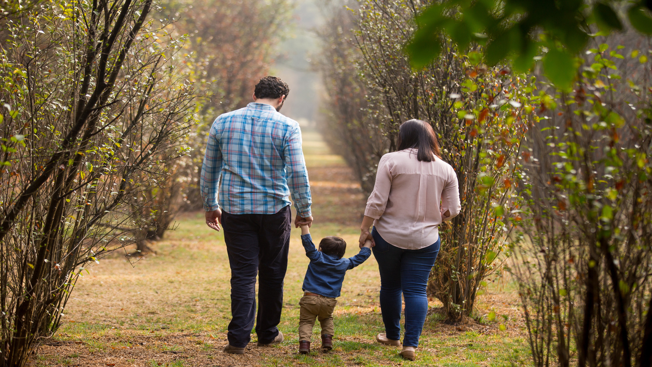 boy walking with his parents