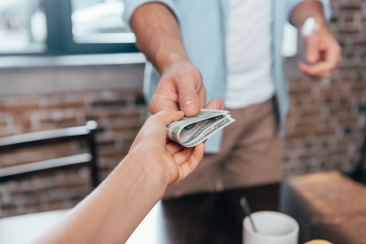 cropped shot of dad giving pocket money to daughter