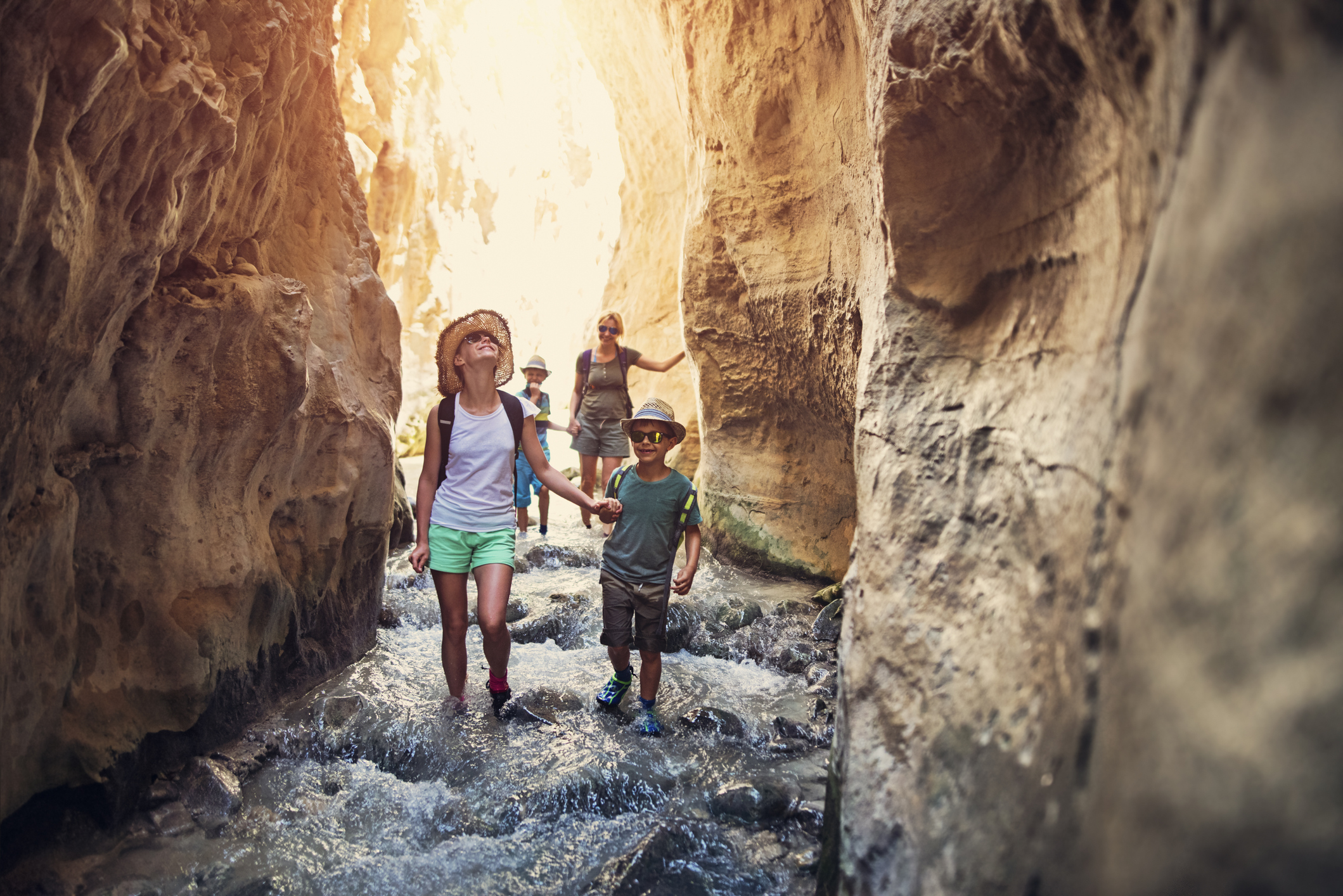 Family hiking through rivier in Andalusia, Spain