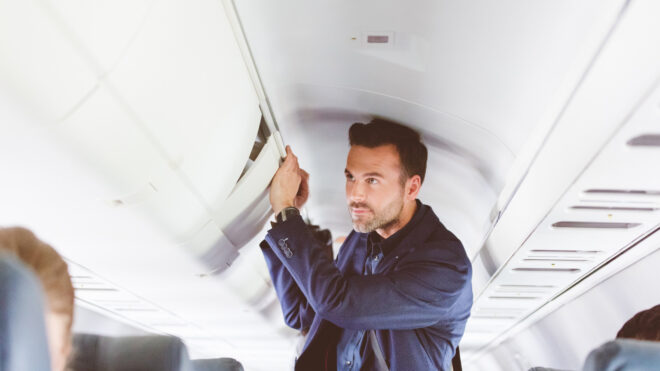 man standing on airplane