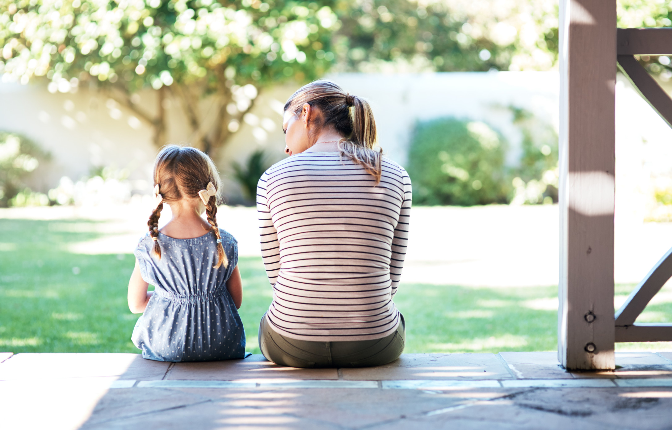 mom and daughter sitting on a porch