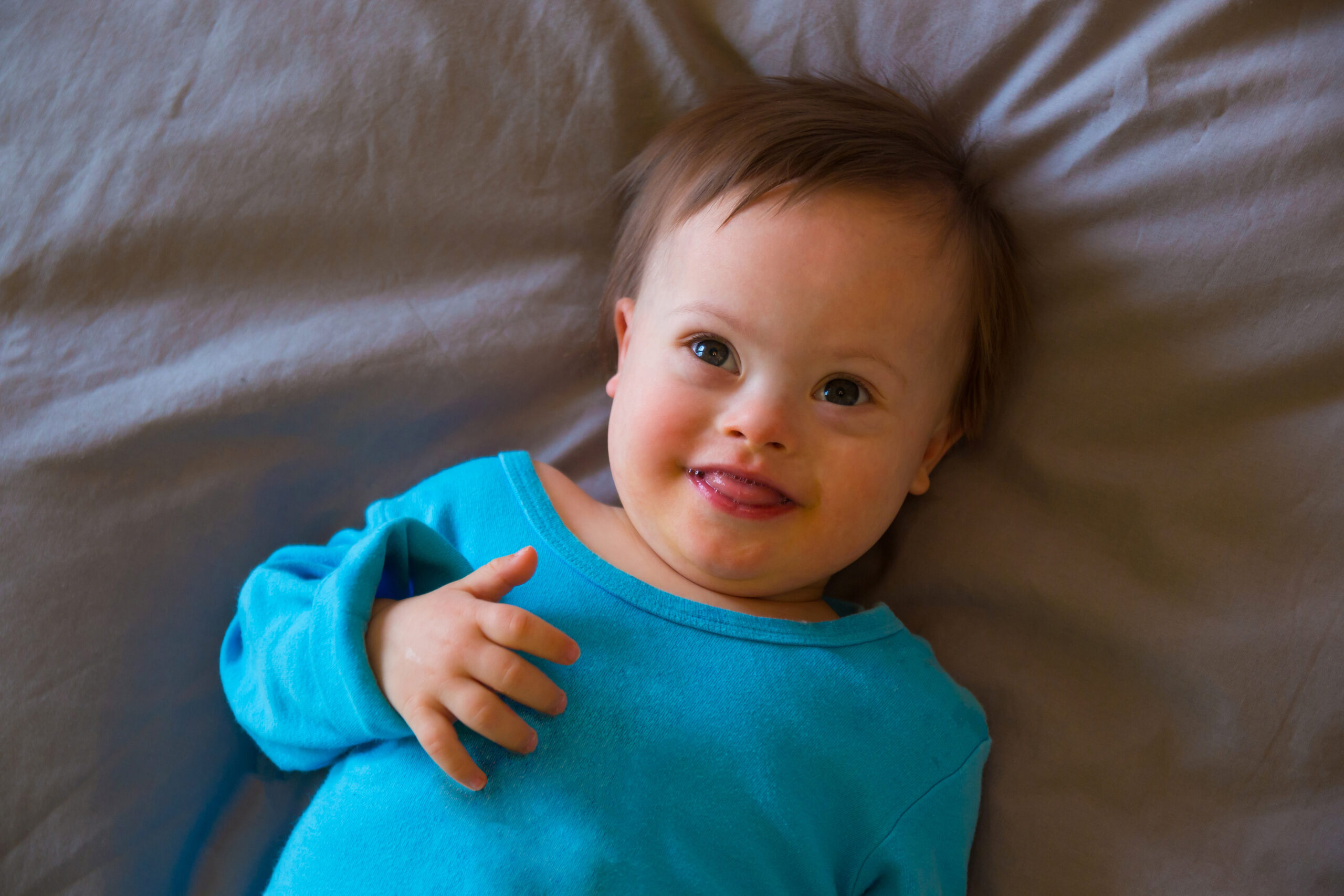 Portrait of cute baby boy with Down syndrome