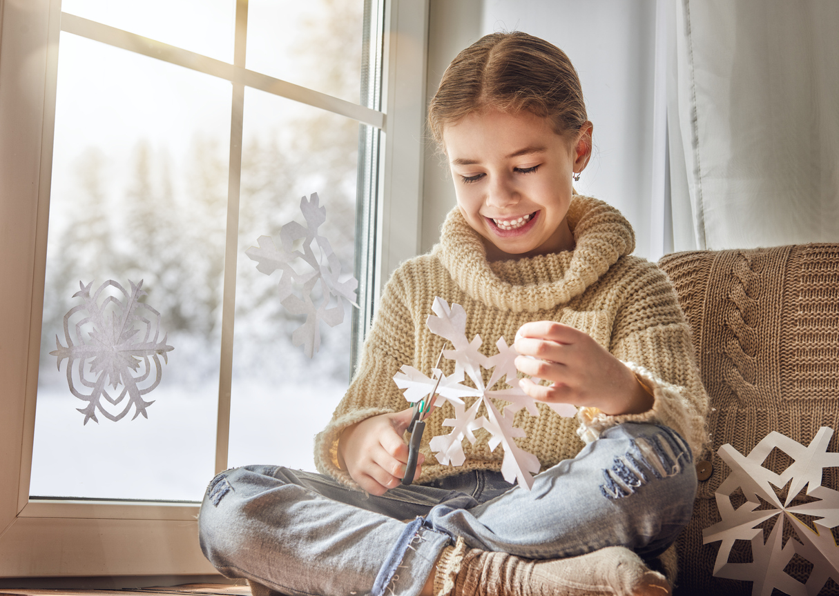 Child makes paper snowflakes