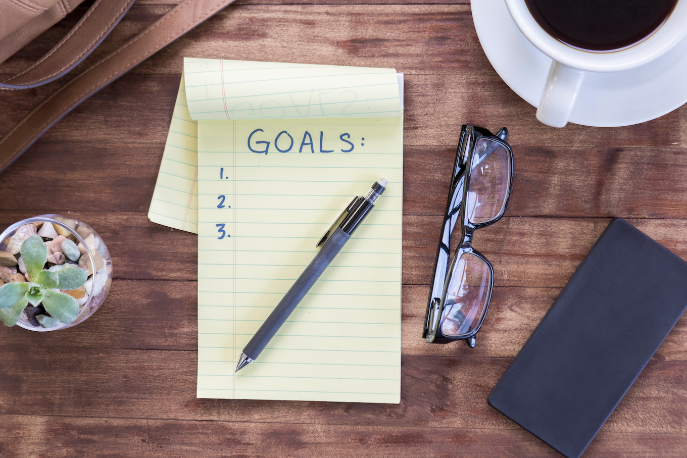 Note pad titled ""goals"" and other belongings