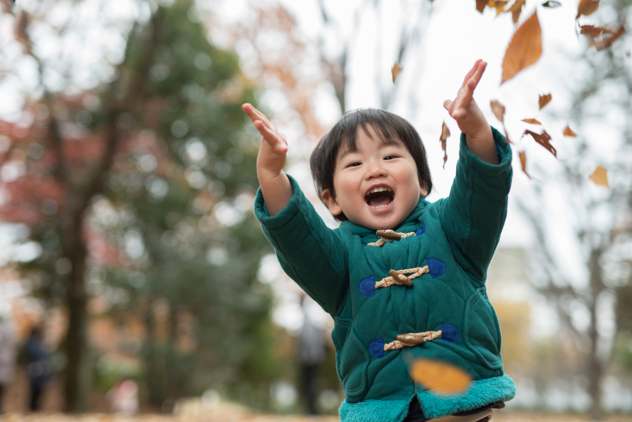child and autumn leaves