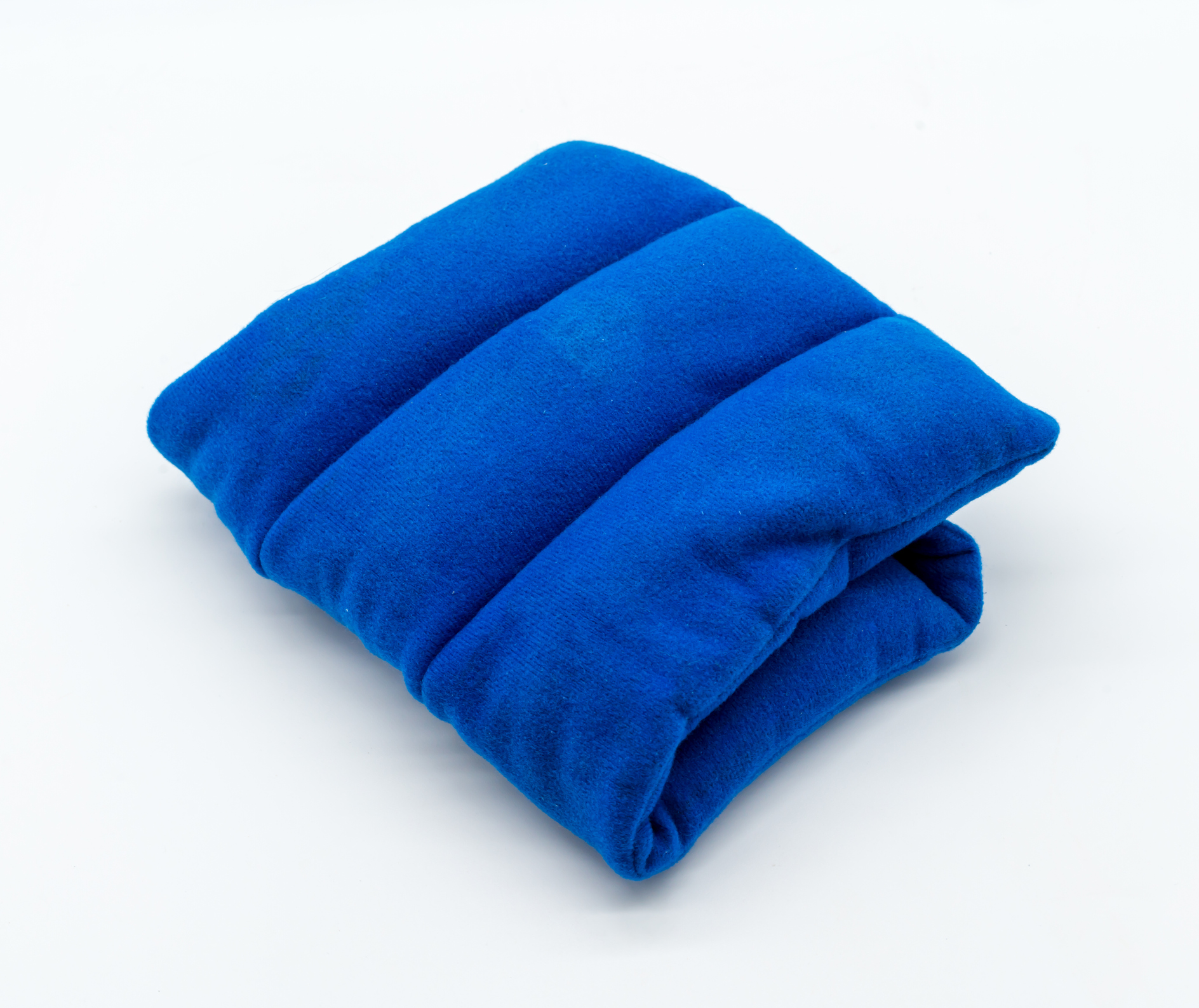 Blue microwave heating pad isolated on white background. Cold and hot wrap for shoulder, neck, back, and body pain relief therapy.