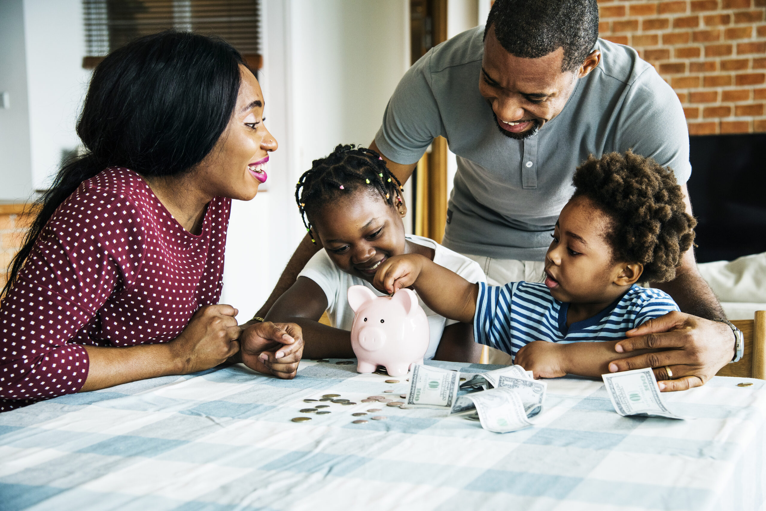 Family saving money to piggy bank Family saving money to piggy bank