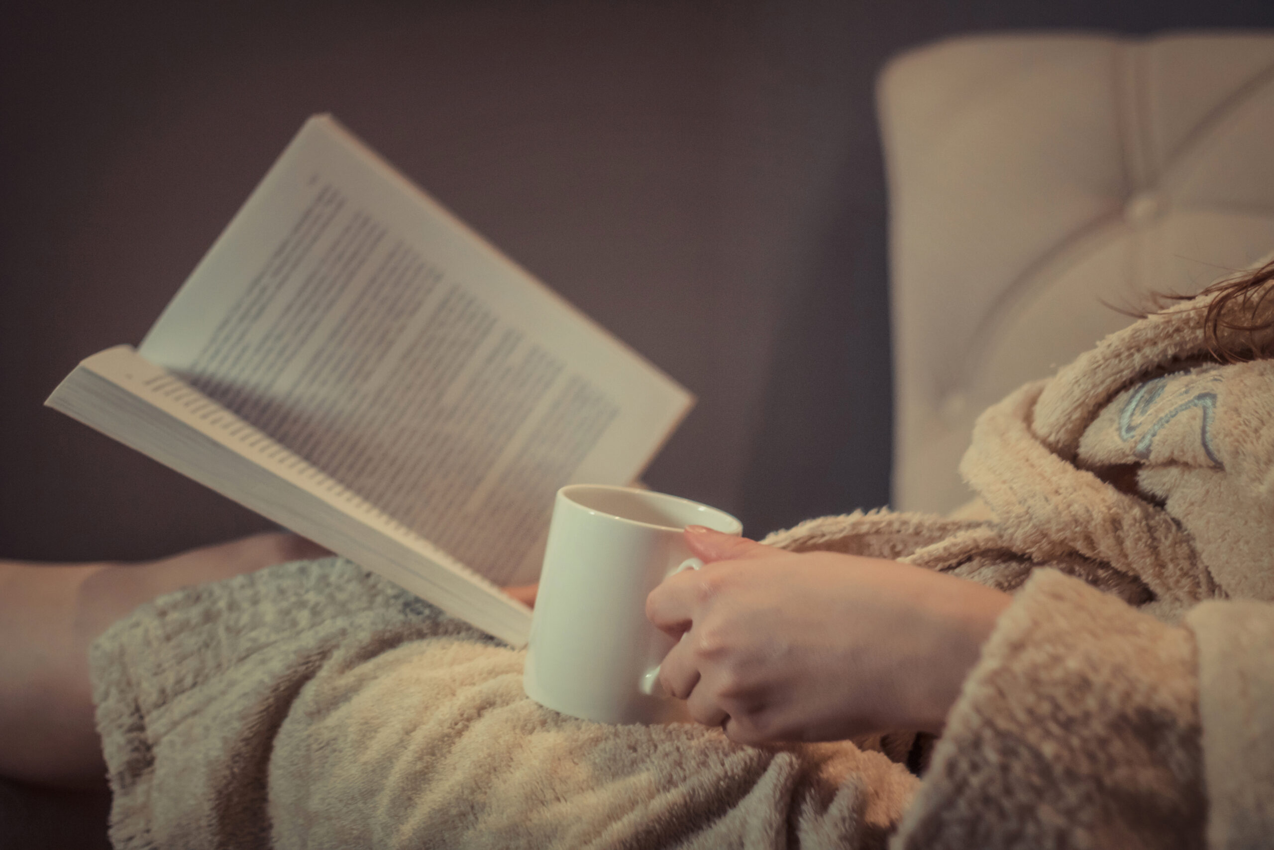 Cozy night with book and cup of tea.