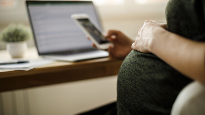pregnant woman on her phone