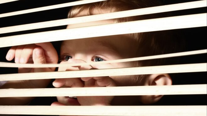 boy-looking-through-blinds