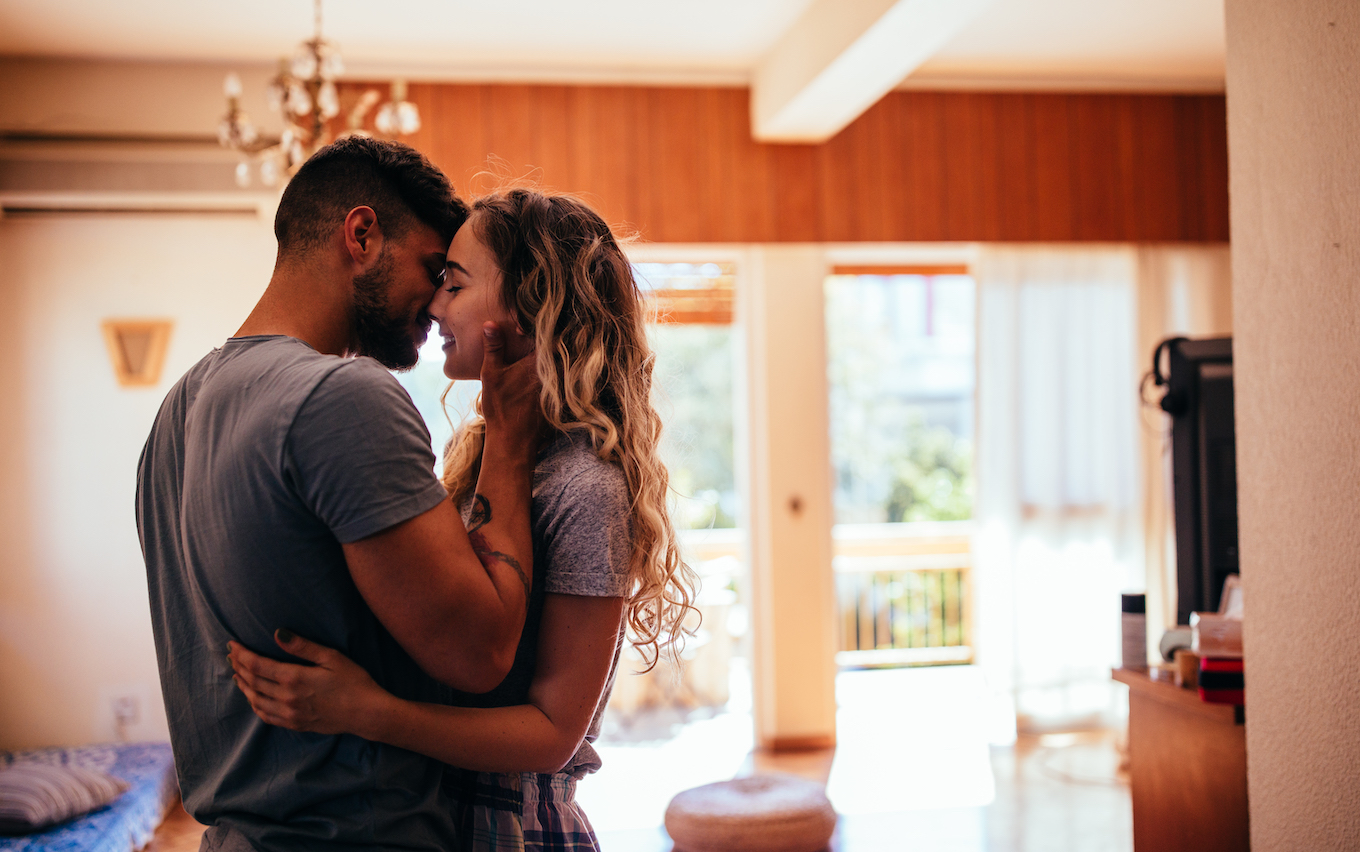 Romantic young hipster couple kissing