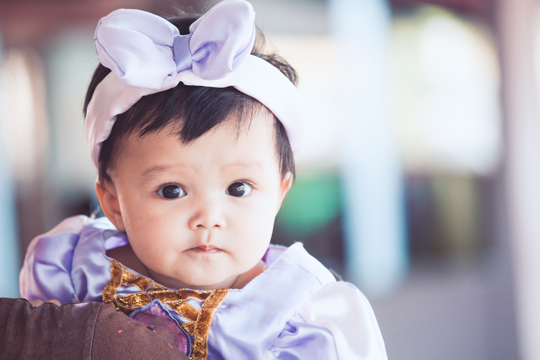 Portrait of cute asian baby girl wearing beautiful bow on her head with lovely