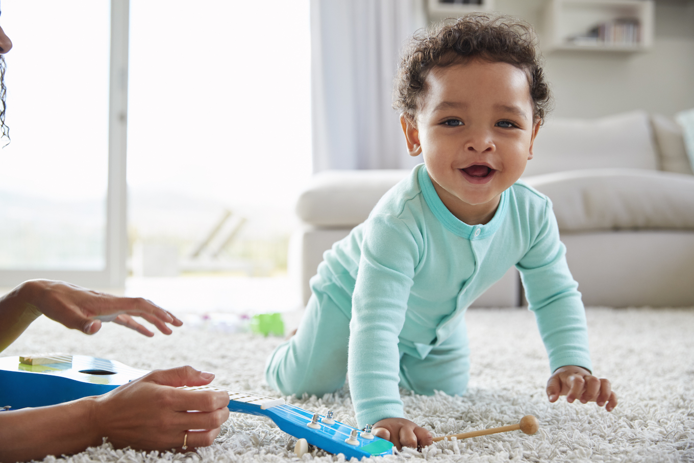 Mixed race mum and toddler son playing at home, close up