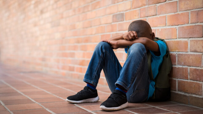 Boy with head on knees