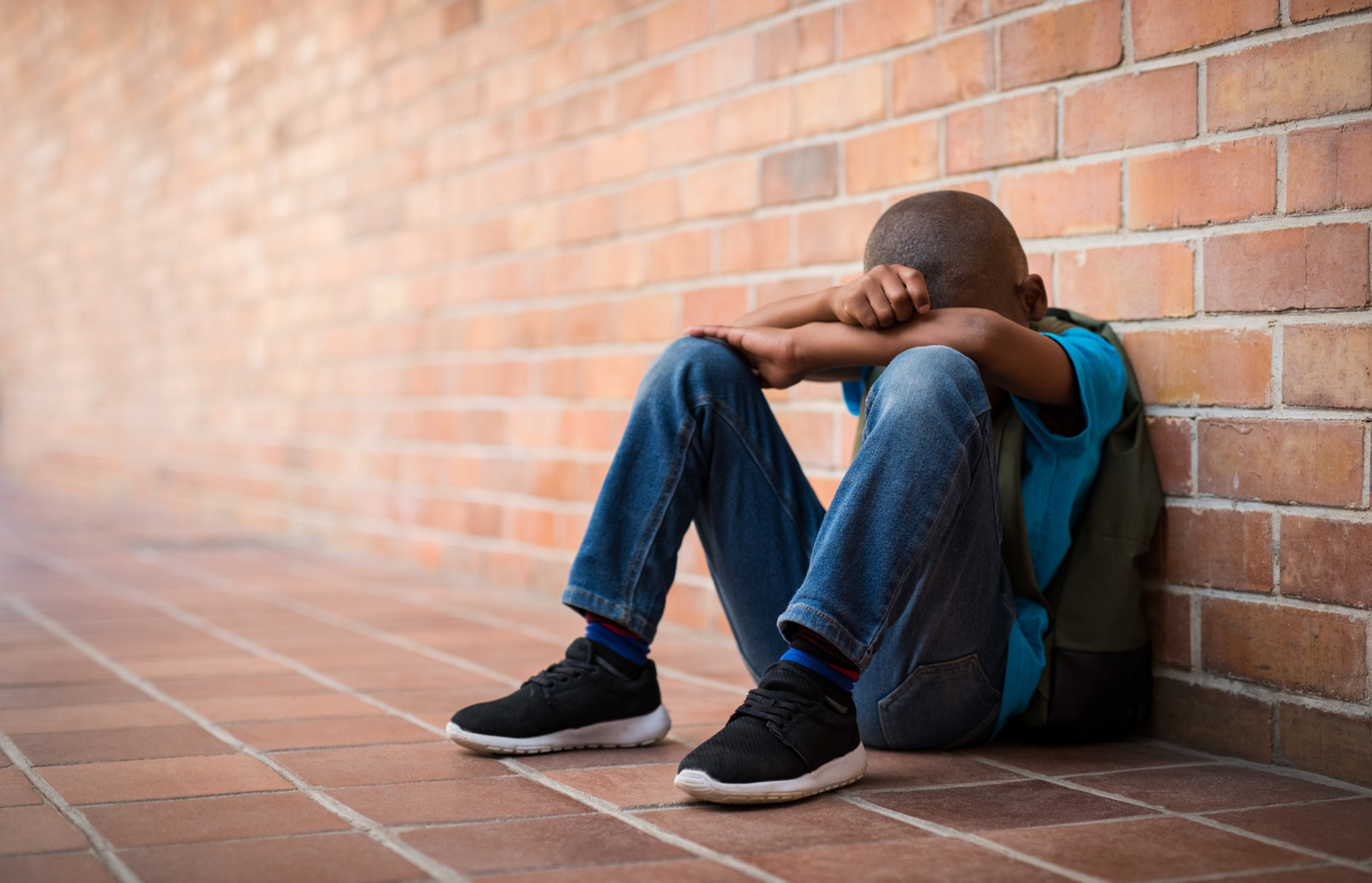 Boy with head on knees