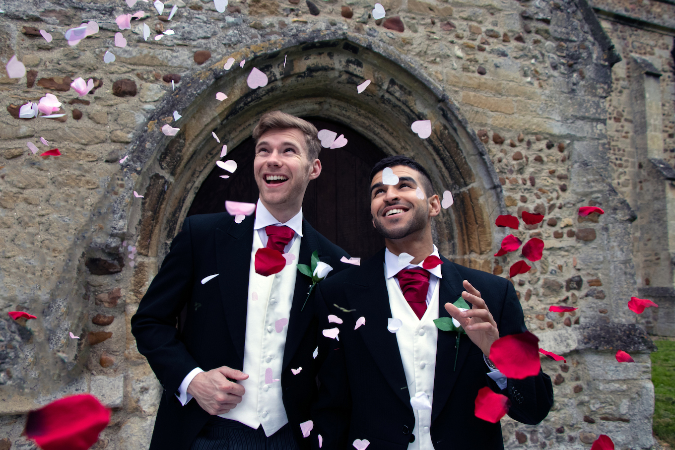 Gay wedding, grooms leave village church after being married to smiles and confetti
