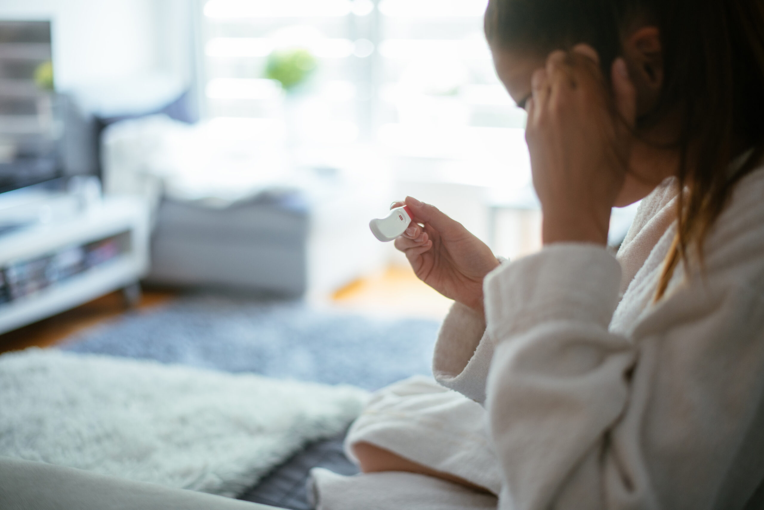 Woman looking at home pregnancy test