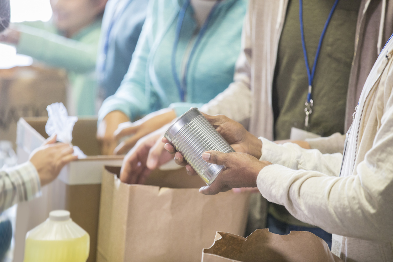 Unrecognizable people volunteering in food bank