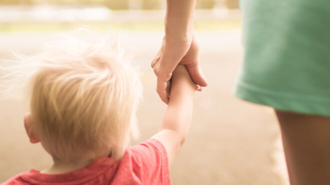toddler boy holding hand